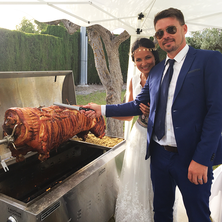 Here we see one of our happy couples about to cut the hog at their wedding